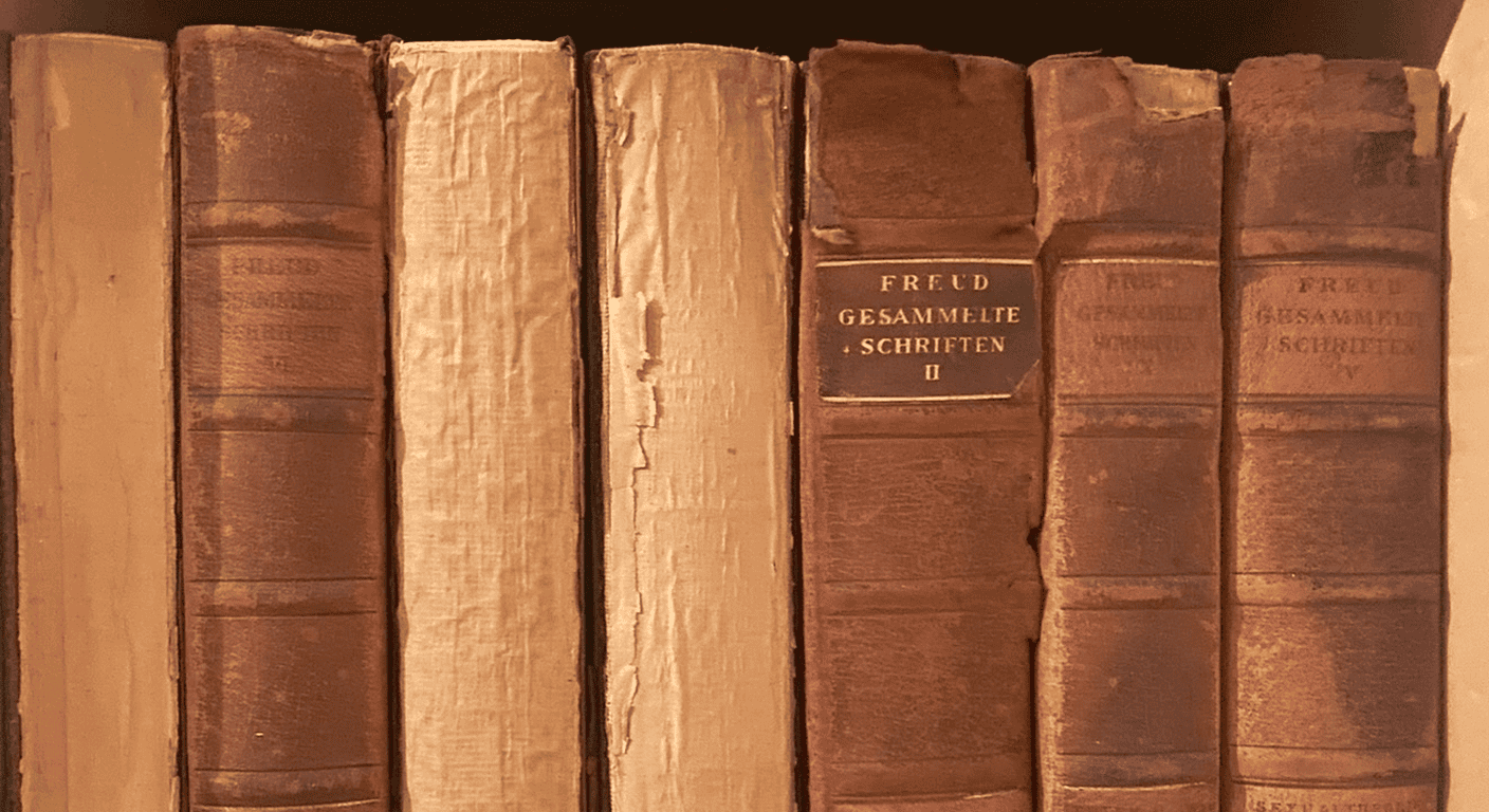 Antique leather-bound volumes of Freud's Gesammelte Schriften on a bookshelf